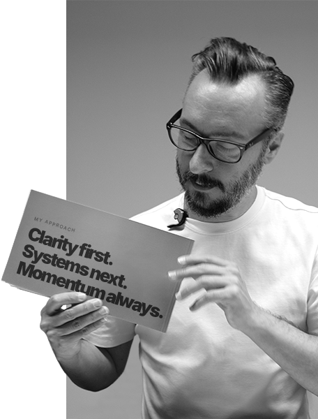 David Yaghoobi holding a book displaying his approach: Clarity first, Systems next, Momentum always